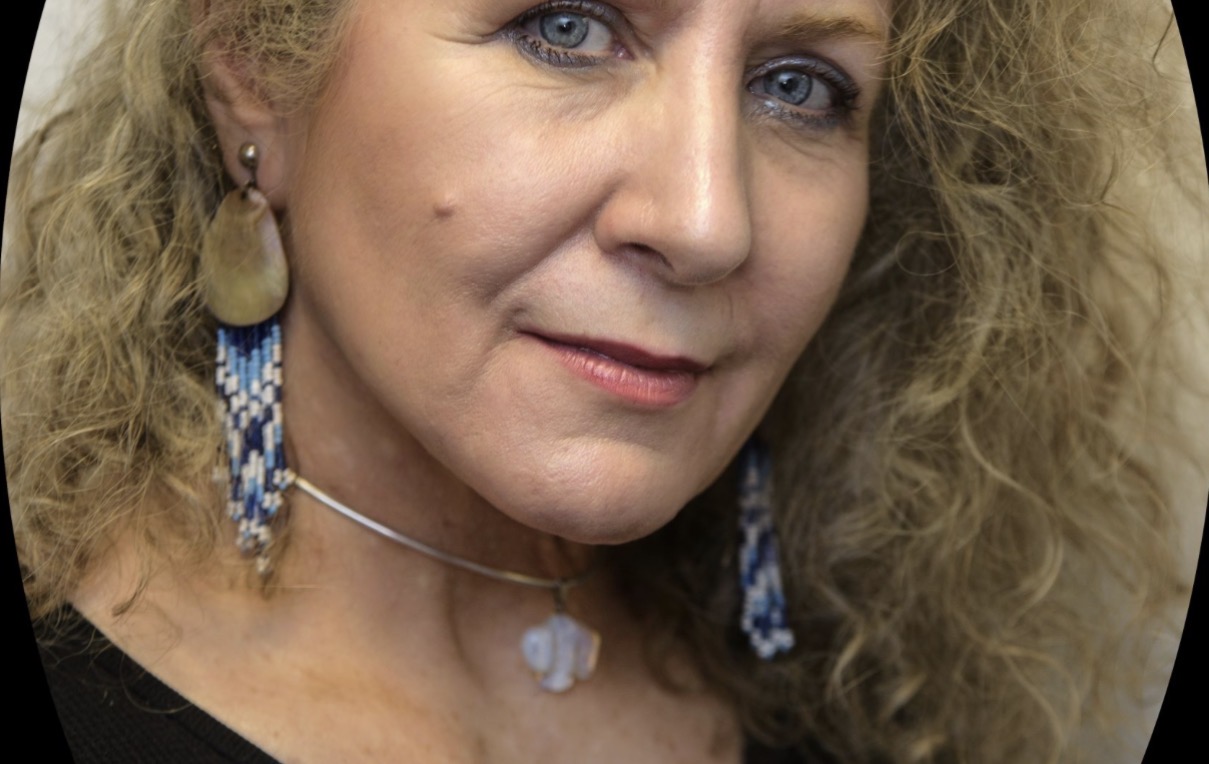 Bunny Sings Wolf — close-up portrait with beaded earrings
